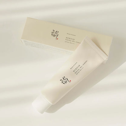 Beauty of Joseon Relief Sun : Rice + Probiotics SPF50+ PA++++ tube lying beside its cream-coloured carton box on a white background