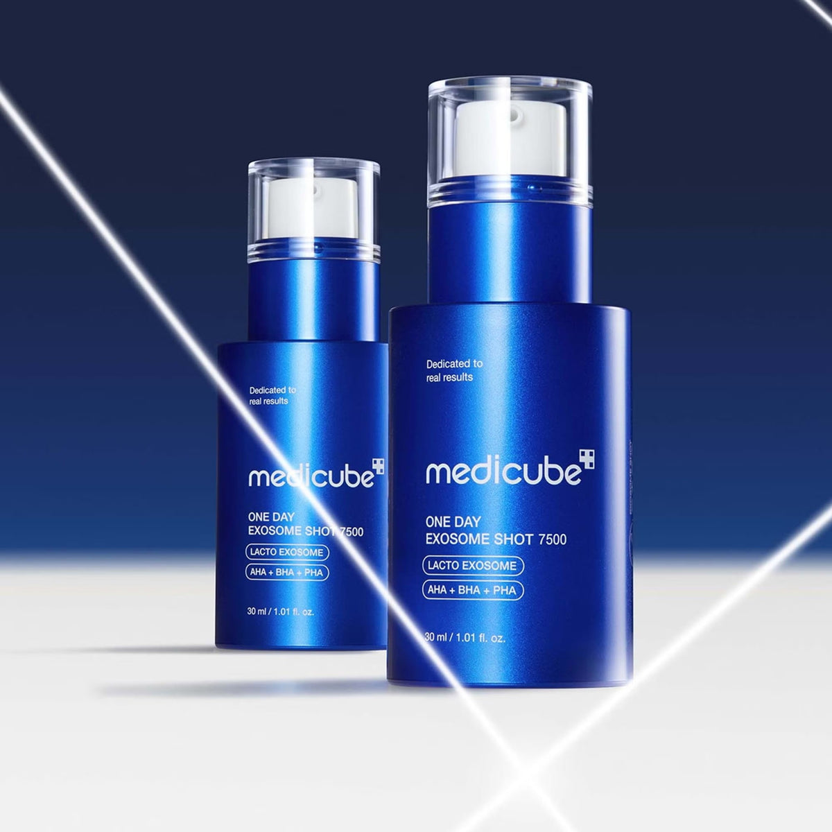 Two medicube One Day Exosome Shot 7500 blue bottles of different sizes on a dark blue background