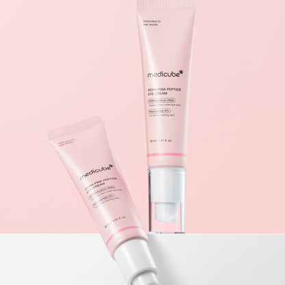 Two medicube PDRN Pink Peptide Eye Cream 30 ml tubes displayed diagonally on a pink background